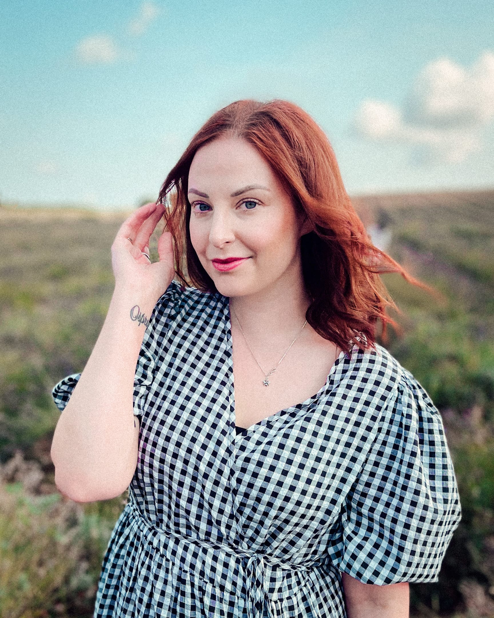 Photograph shows me, Katie, a white woman with red hair standing in a lavender field